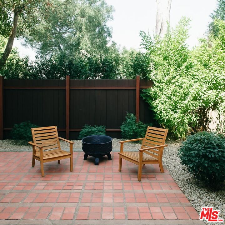 13239 Addison Street Sherman Oaks, CA 91423 - Photo 28 of 29 a backyard of a house with wooden chairs and a fire pit