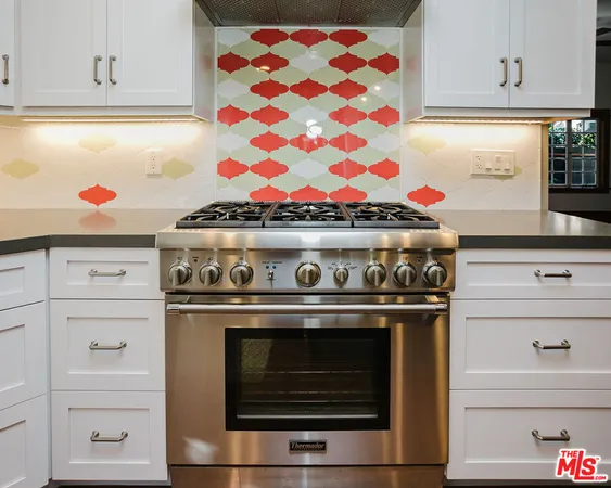 a view of kitchen with sink and refrigerator