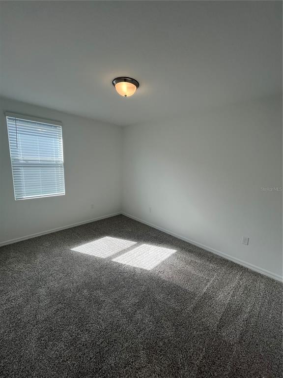 2405 White Tail Street Davenport, FL 33837 - Photo 12 of 24 an empty room with a empty space and window
