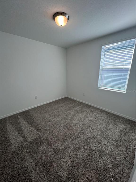 2405 White Tail Street Davenport, FL 33837 - Photo 14 of 24 an empty room with a window