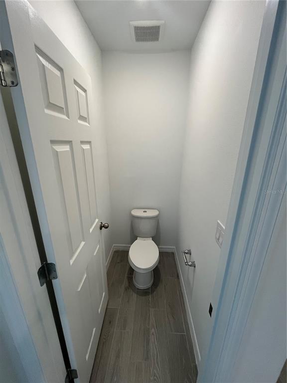 2405 White Tail Street Davenport, FL 33837 - Photo 18 of 24 a bathroom with a granite countertop toilet and a sink