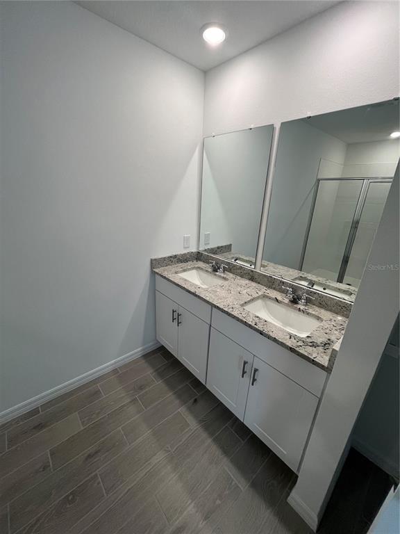 2405 White Tail Street Davenport, FL 33837 - Photo 20 of 24 a bathroom with a granite countertop sink and a mirror