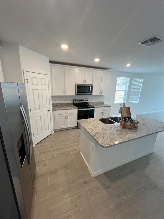 2405 White Tail Street Davenport, FL 33837 - Photo 5 of 24 a kitchen with a stove a refrigerator and a sink
