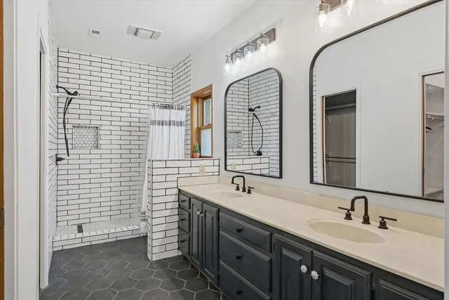 a bathroom with a double vanity sink mirror and double