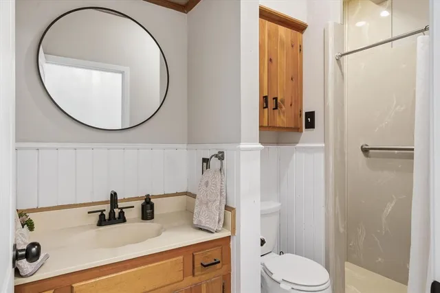 a bathroom with a sink a toilet and a mirror