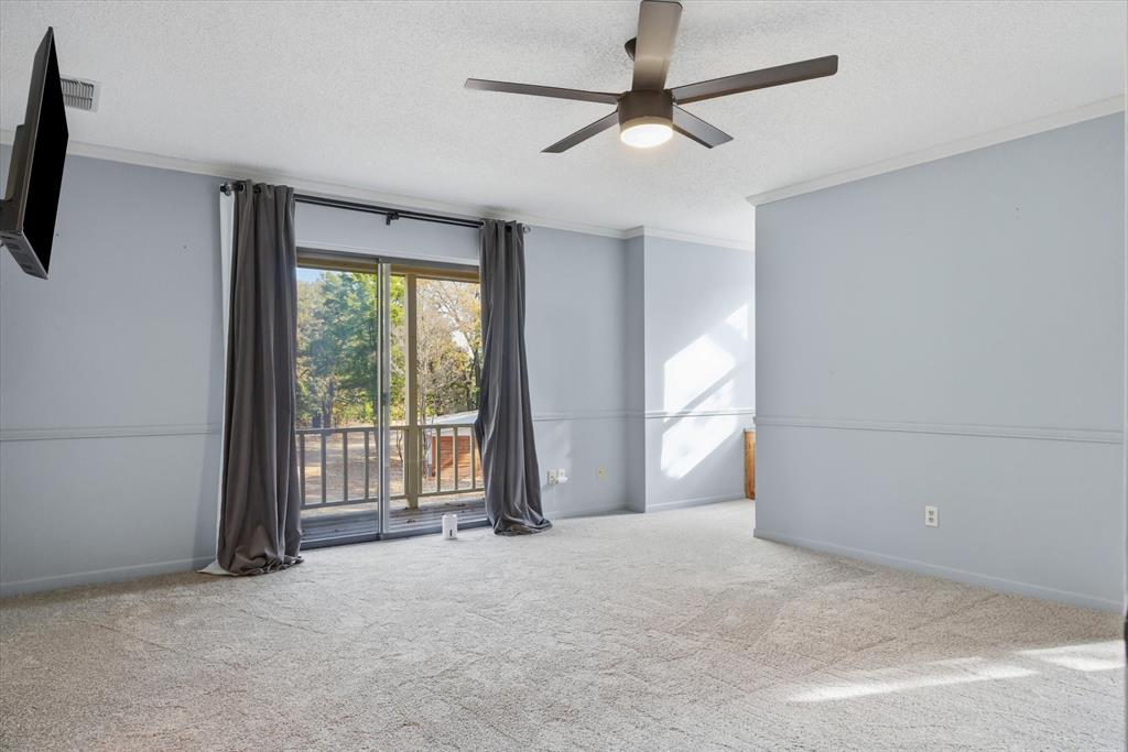 4969 County Road 3502 Wills Point, TX 75169 - Photo 17 of 40 an empty room with windows and fan