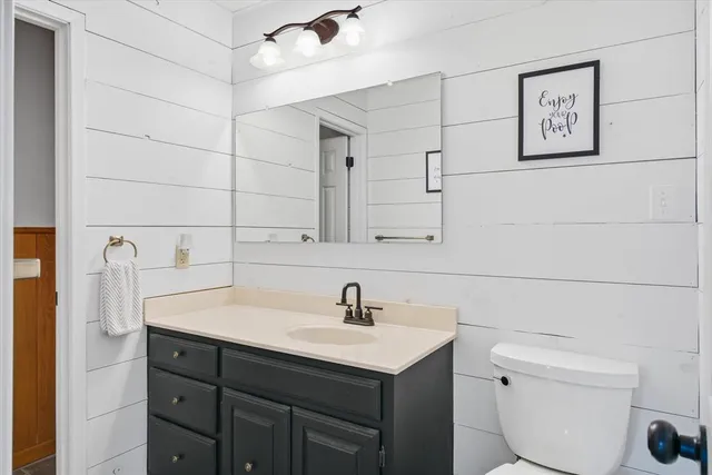 a bathroom with a sink toilet and vanity