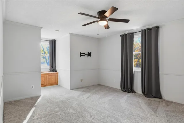 an empty room with closet and windows