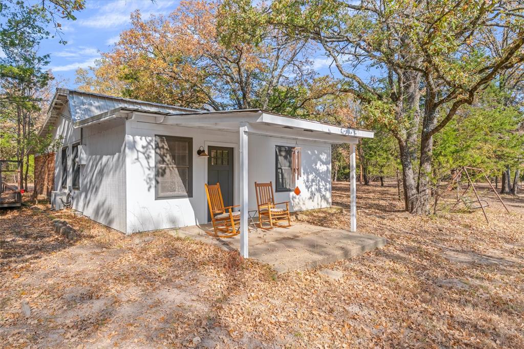 4969 County Road 3502 Wills Point, TX 75169 - Photo 27 of 40 a view of a chair and table in backyard of the house