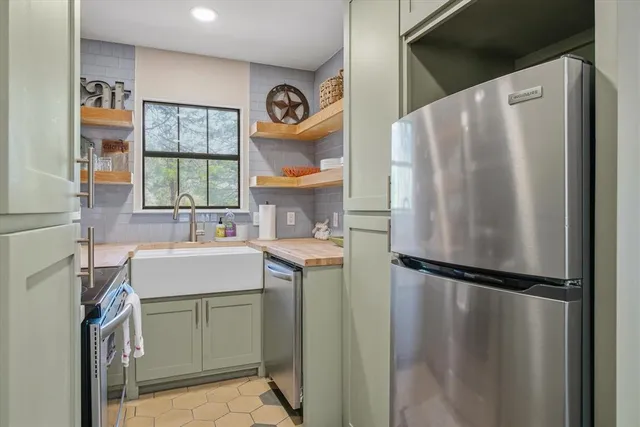a kitchen with a sink cabinets and wooden floor