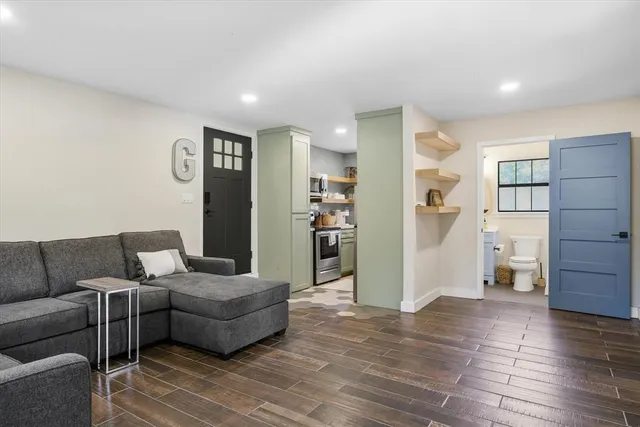 a bathroom with a toilet sink and mirror