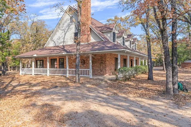 a backyard of a house with oven and a tree