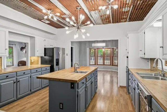 a kitchen with a sink refrigerator and microwave