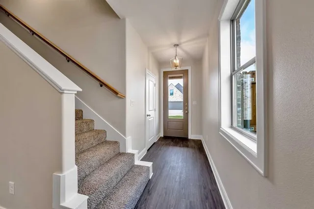 a view of entryway and hall with wooden floor