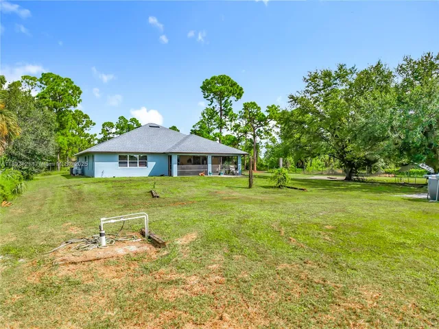 a view of a swimming pool and deck in the backyard