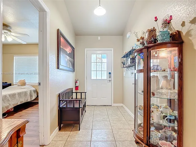 a view of an entryway with a flower pot and a living room