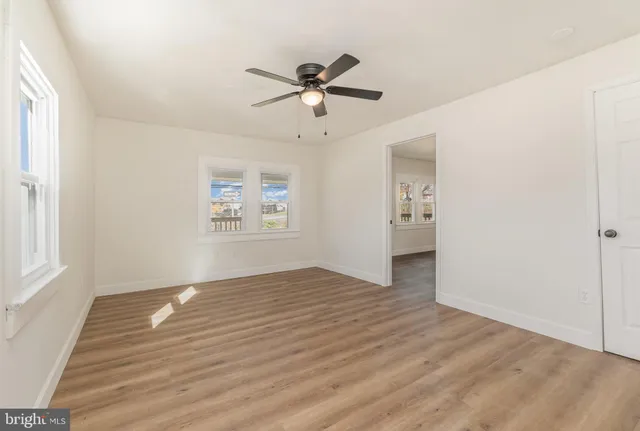 wooden floor in an empty room with a window