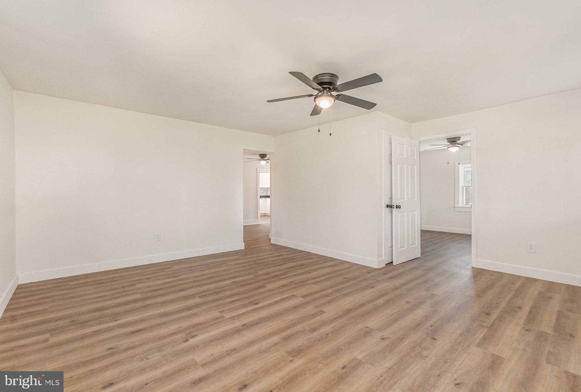 11 Bush Chapel Road Aberdeen, MD 21001 - Photo 16 of 39 a view of a big room with wooden floor a ceiling fan and closet area