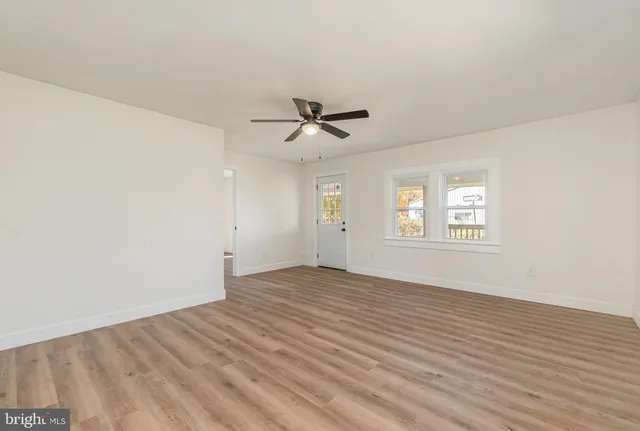 wooden floor in an empty room with a window