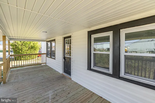 a view of a room with wooden floor and windows