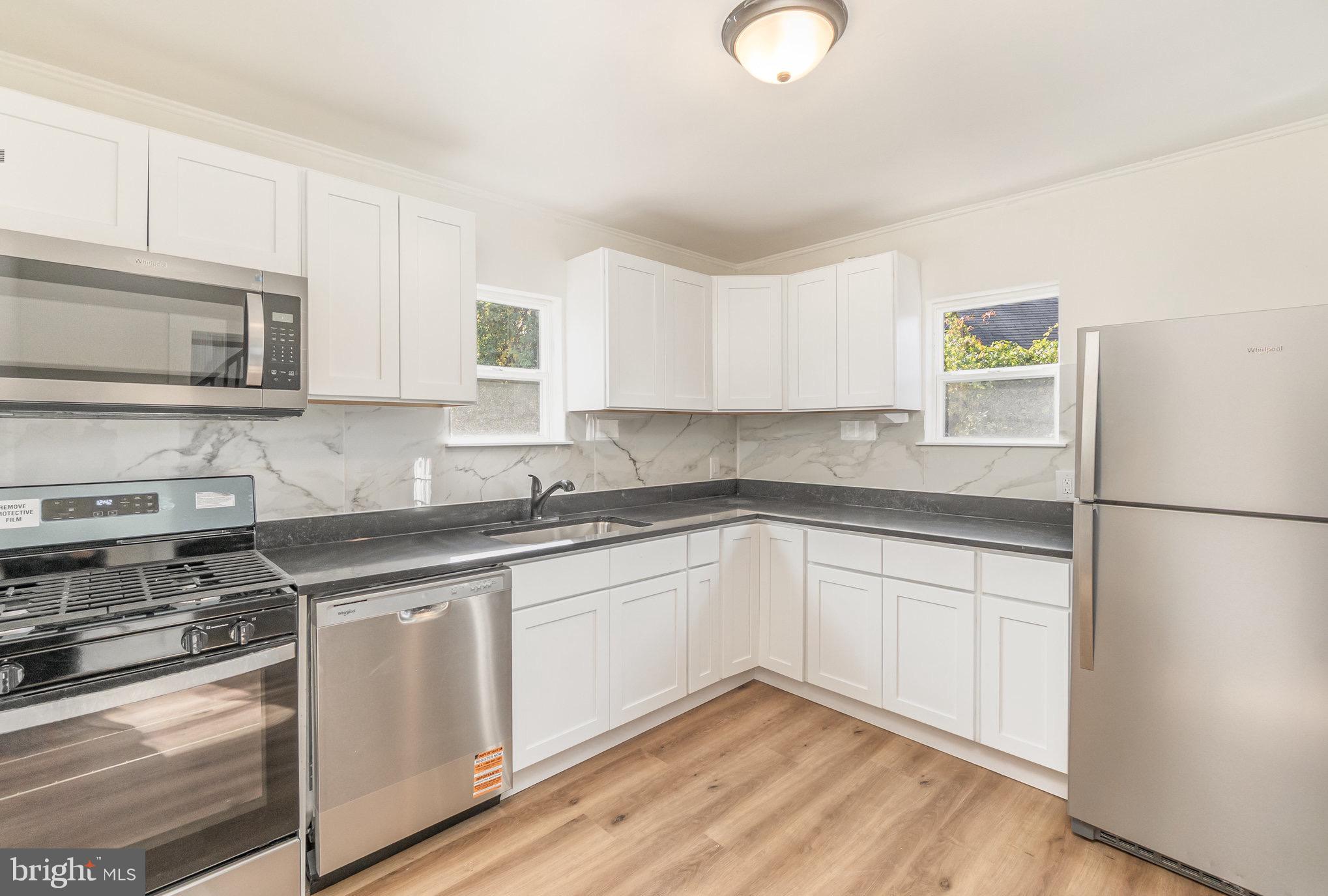 11 Bush Chapel Road Aberdeen, MD 21001 - Photo 6 of 39 a kitchen with cabinets appliances a sink and a window