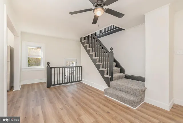 a view of entryway and hall with wooden floor