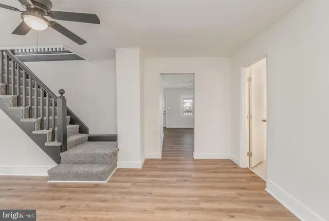 a view of entryway and hall with wooden floor