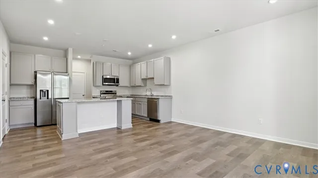 a kitchen with a refrigerator and white cabinets
