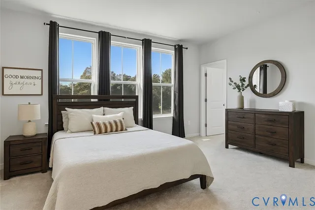 a bedroom with a large bed and a large window