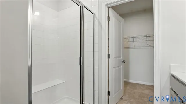 a large bed sitting in a bedroom next to a window