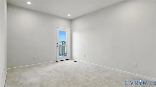 a view of a balcony with wooden floor & fence