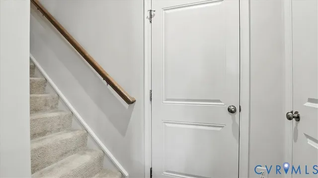 a view of staircase with white walls