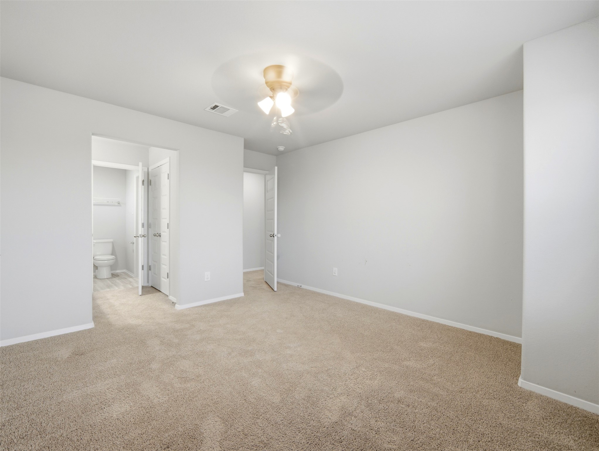 60 Bent Trl Lane Georgetown, TX 78628 - Photo 17 of 40 A spacious, neutral-toned room features soft carpeting and direct access to a private toilet area.