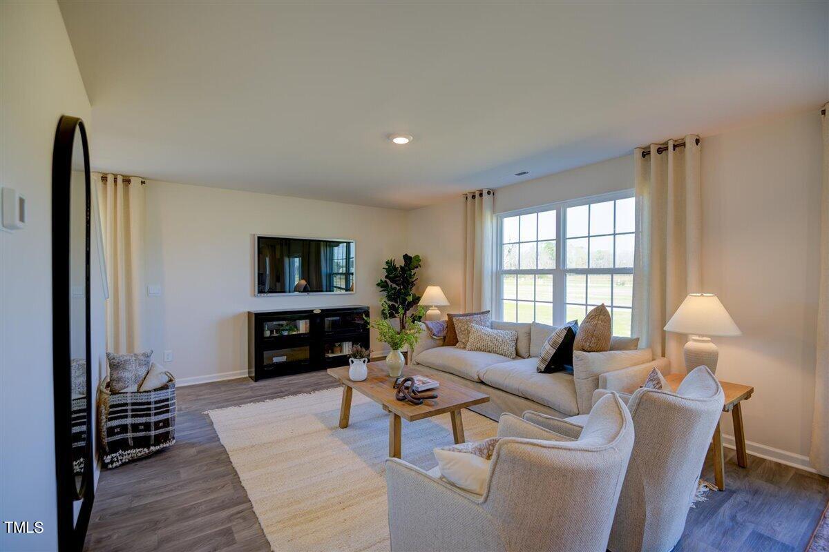 3609 Drafton Drive Raleigh, NC 27610 - Photo 16 of 40 a living room with fireplace furniture and a flat screen tv