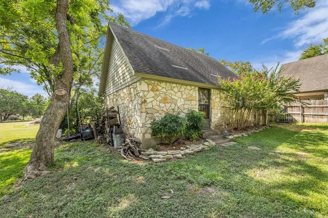an aerial view of a house with a yard