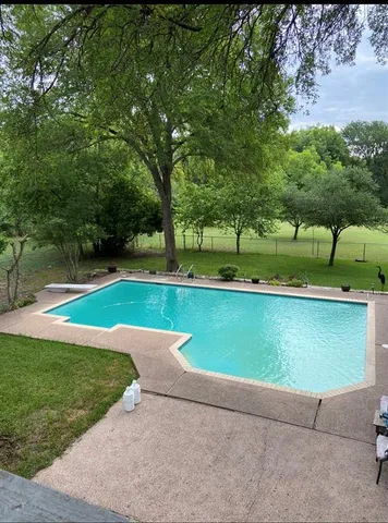 a view of a yard with wooden fence