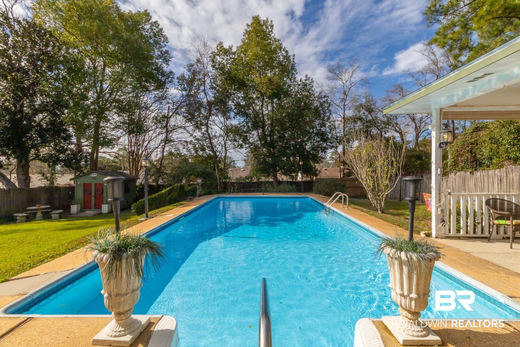 556 Stuart Street Daphne, AL 36526 - Photo 2 of 25 View of swimming pool featuring a storage unit and a lawn