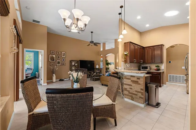 a utility room with stainless steel appliances granite countertop a sink and cabinets with wooden floor