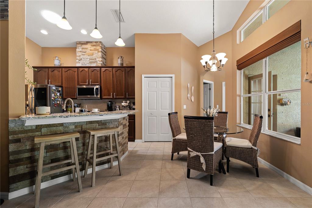 9020 North River Road Tampa, FL 33635 - Photo 16 of 86 a view of a dining room with furniture and chandelier