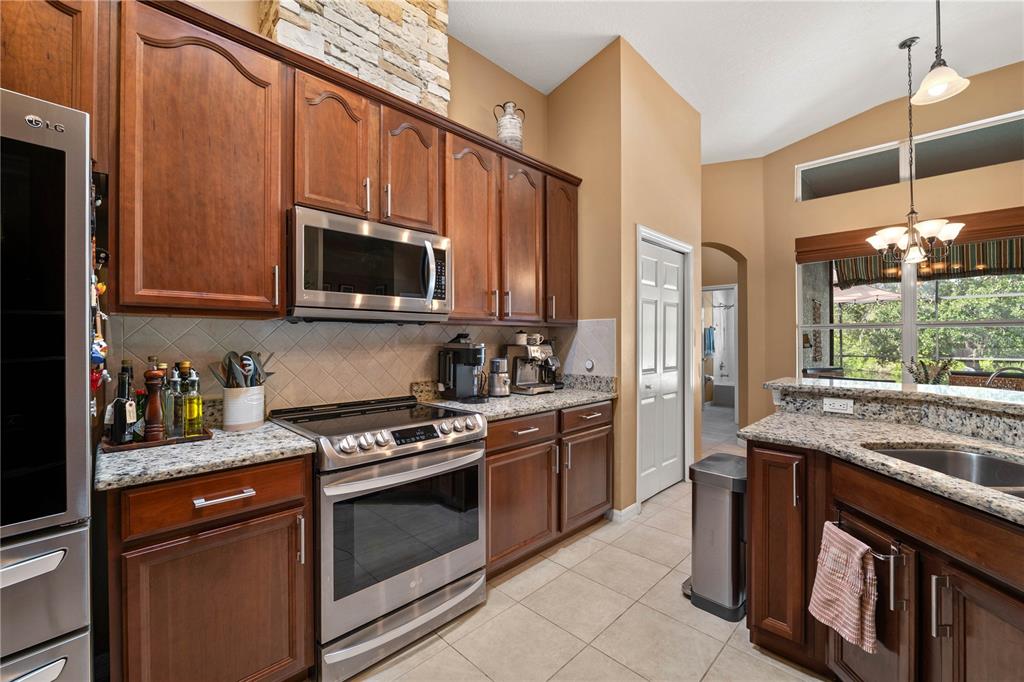 9020 North River Road Tampa, FL 33635 - Photo 20 of 86 a kitchen with stainless steel appliances granite countertop a stove a sink and a microwave