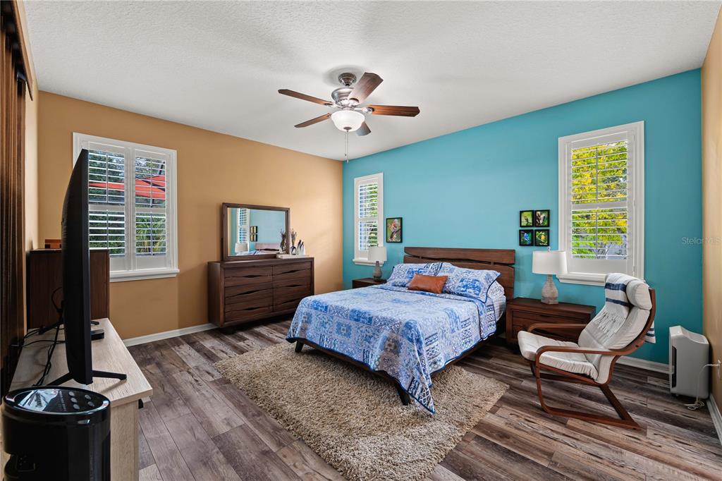 9020 North River Road Tampa, FL 33635 - Photo 23 of 86 a bedroom with a bed and a flat screen tv