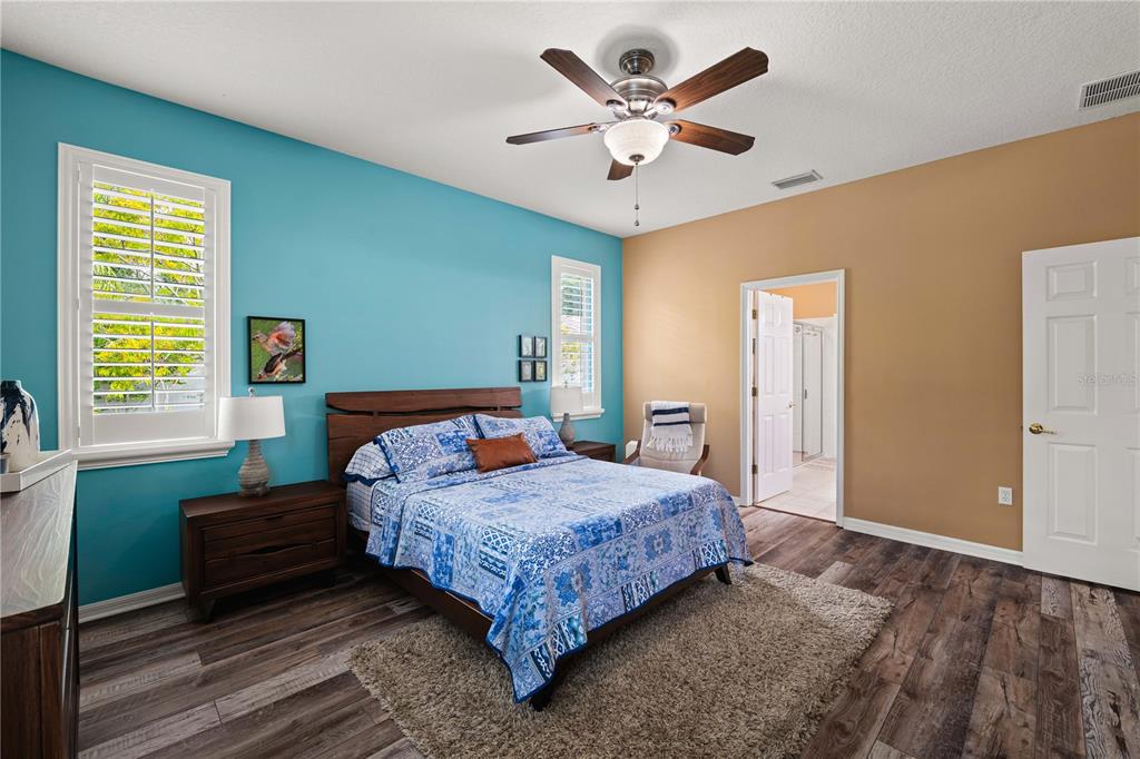 9020 North River Road Tampa, FL 33635 - Photo 24 of 86 a bedroom with a large bed and a chandelier