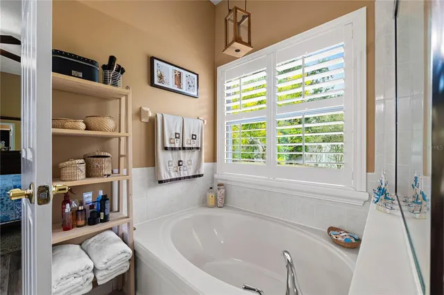 a bathroom with a granite countertop sink a toilet and shower curtain