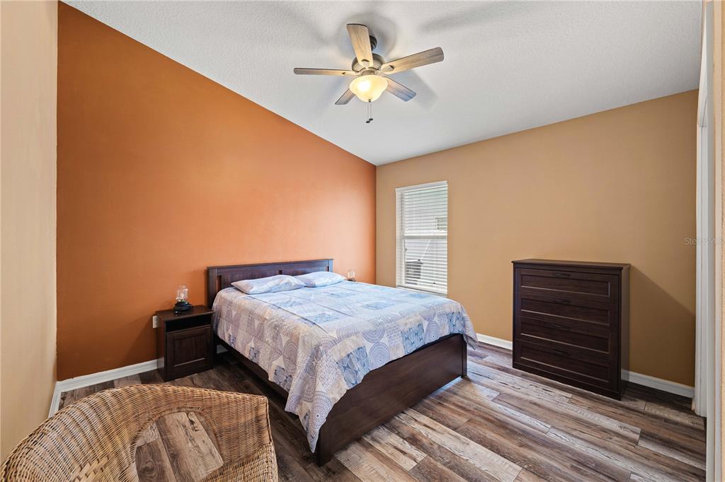 9020 North River Road Tampa, FL 33635 - Photo 30 of 86 a bedroom with a bed and a chandelier