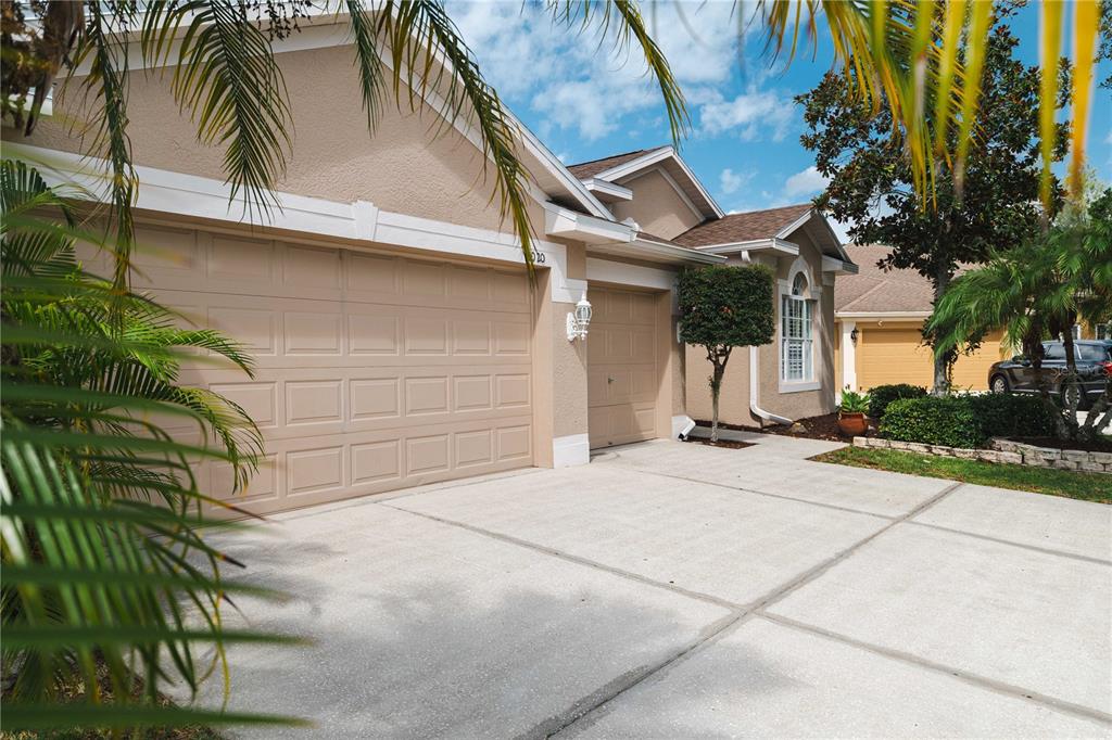 9020 North River Road Tampa, FL 33635 - Photo 3 of 86 a front view of a house with a yard