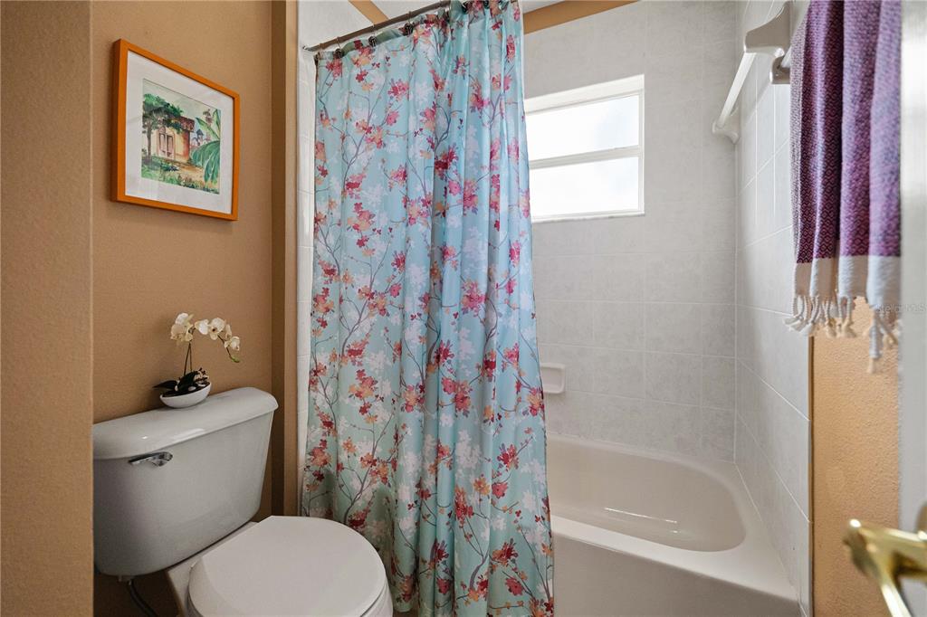 9020 North River Road Tampa, FL 33635 - Photo 33 of 86 a white toilet sitting next to a bath tub