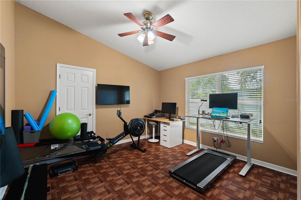 9020 North River Road Tampa, FL 33635 - Photo 37 of 86 a room with furniture and a flat screen tv