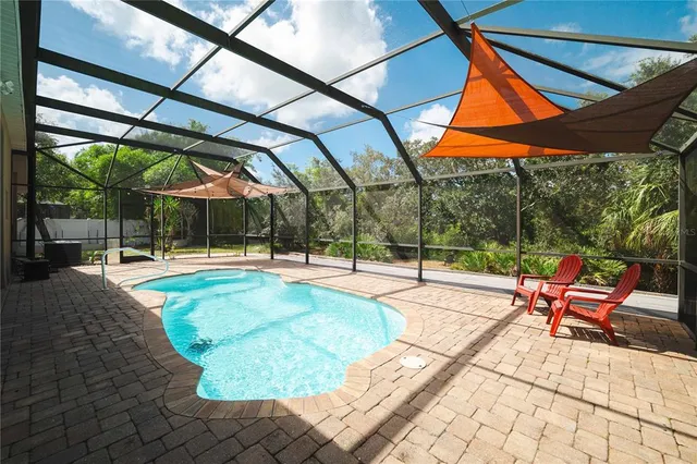 an aerial view of a house with a yard and lake view