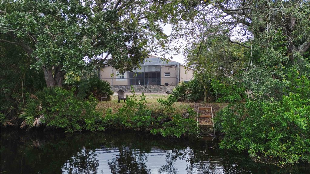 9020 North River Road Tampa, FL 33635 - Photo 59 of 86 a front view of a house with a yard and lake view