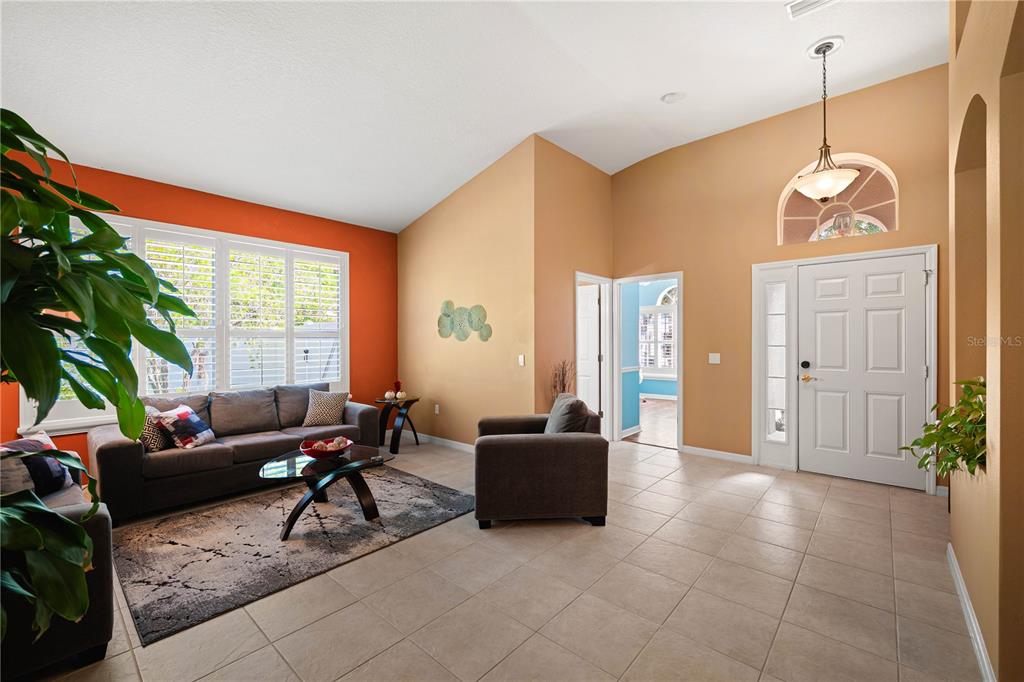 9020 North River Road Tampa, FL 33635 - Photo 6 of 86 a living room with furniture potted plant and a large window